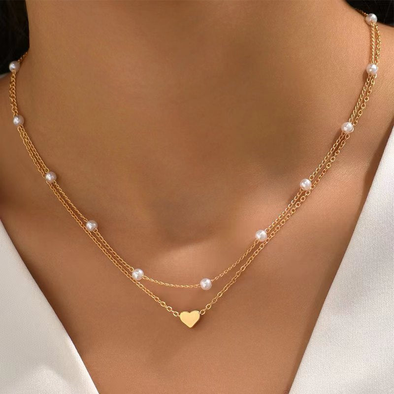 Double necklace with heart and pearls