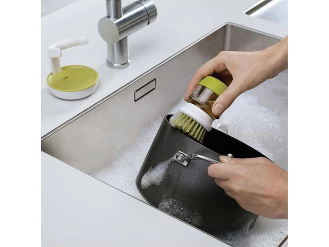 Washing-up brush with soap dispenser