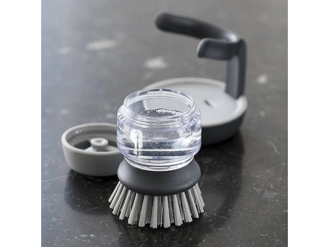 Washing-up brush with soap dispenser